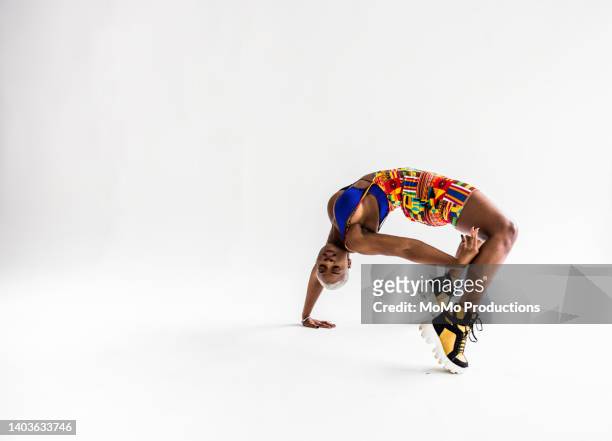 studio portrait of fashionable female professional dancer - bending over backwards stockfoto's en -beelden