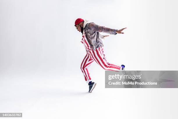 studio portrait of fashionable male professional dancer - guy dancing music dynamic stock pictures, royalty-free photos & images