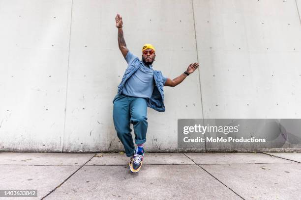 fashionable male professional dancer on urban sidewalk, full length - hip hop t shirt stock pictures, royalty-free photos & images