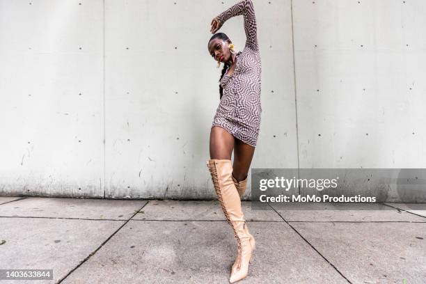 fashionable female professional dancer on urban sidewalk, full length - black dress stock pictures, royalty-free photos & images