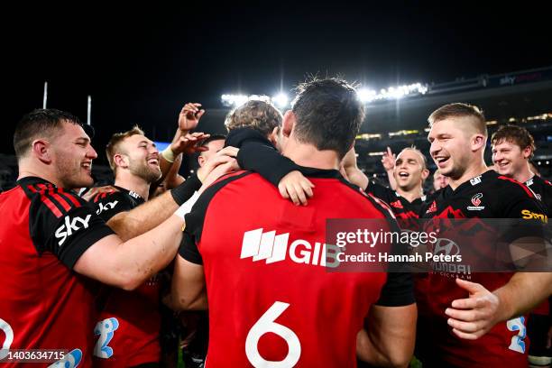 Pablo Matera of the Crusaders holds his son amid celebrations after the 2022 Super Rugby Pacific Final match between the Blues and the Crusaders at...