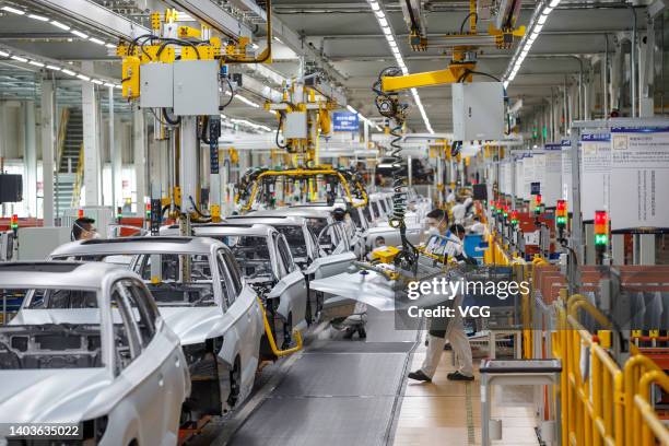 Employees work on the assembly line of Jetta VS7 SUV at the Chengdu branch of FAW-Volkswagen Automobile Co., Ltd, a joint venture between FAW Group...