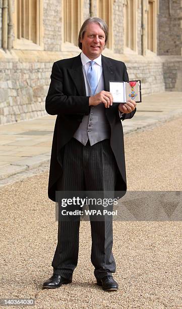 Chair of the England and Wales Cricket Board, Giles Clarke, poses with his CBE, which was presented by Queen Elizabeth II at Windsor Castle on March...