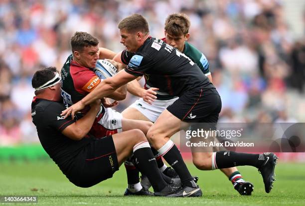 George Ford of Leicester Tigers is tackled by Jamie George and Owen Farrell of Saracens during the Gallagher Premiership Rugby Final match between...