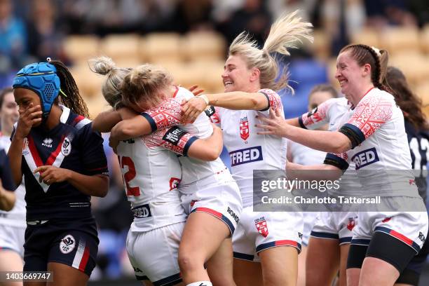 Hollie Dodd of England celebrates scoring their side's first try with teammates Georgia Roche, Tara Stanley and Olivia Wood during the Women's...