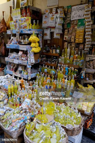 Souvenir shop displays bottles of Limoncello and fresh lemons and other local produces of Amalfi Coast placed on racks outside a shop on April 15,...