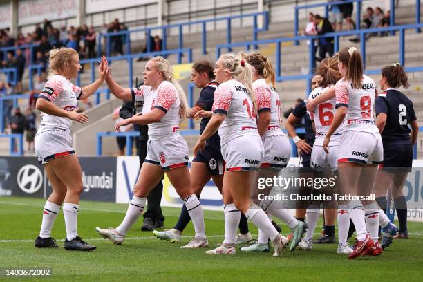 Caitlin Beevers of England celebrates scoring their side's second try with teammates during the Women's International Friendly match between England...