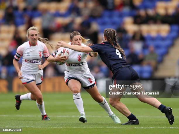 Emily Rudge of England is challenged by Laureane Biville of France during the Women's International Friendly match between England and France at The...