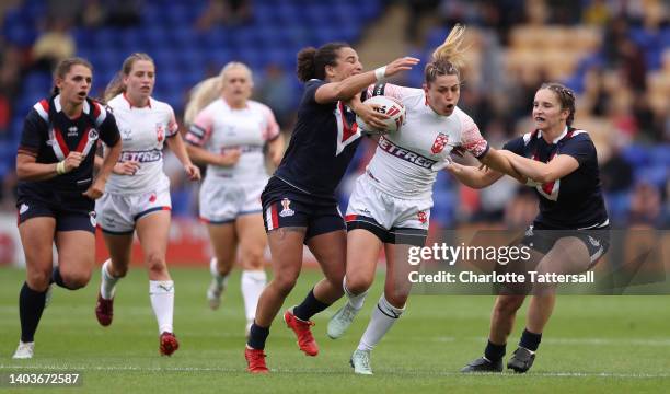 Elisa Ciria and Laureane Biville of France challenge Emily Rudge of England during the Women's International Friendly match between England and...