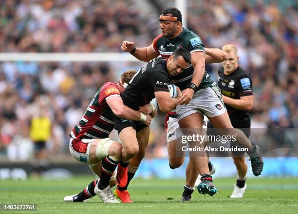 Alex Lozowski of Saracens is tackled by Ollie Chessum and Ellis Genge of Leicester Tigers during the Gallagher Premiership Rugby Final match between...