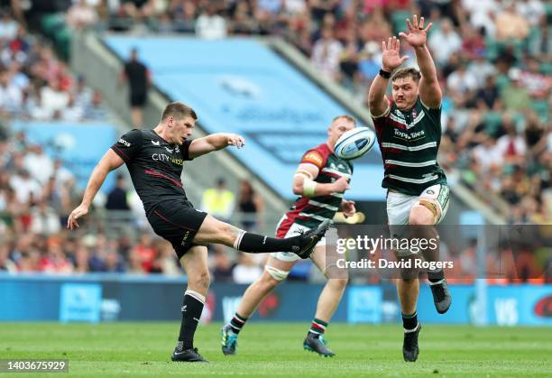 Owen Farrell of Saracens clears the ball whilst under pressure from Jasper Wiese of Leicester Tigers during the Gallagher Premiership Rugby Final...