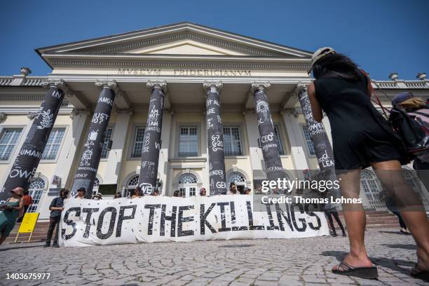 Activist and artist demonstrate in front of the 'Fridericianum' with banner 'Stop The Killings' against the Philippe 'drug war' as an event during...