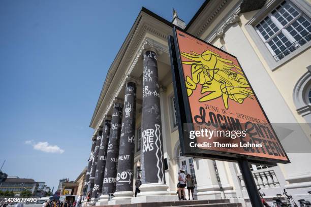 Documenta poster hangs in front of the pillars of the Fridericianum during the opening day of the Documenta 15 modern art fair on June 18, 2022 in...