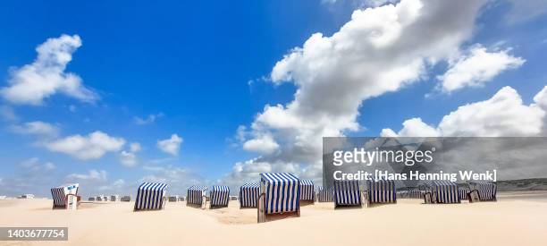 beach chairs on empty beach with blue sky - ostfriesiska öarna bildbanksfoton och bilder
