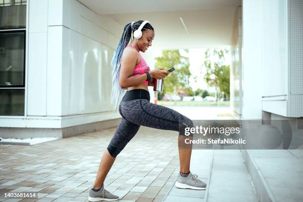 woman uses a mobile phone - woman headphones sport smile iphone stock pictures, royalty-free photos & images