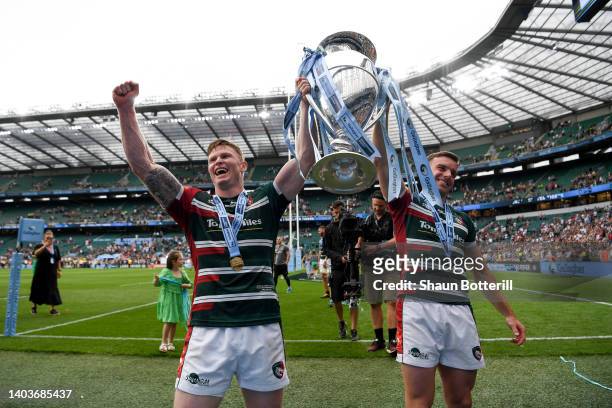 Chris Ashton and George Ford of Leicester Tigers lift the Gallagher Premiership Trophy as they celebrate with fans after the final whistle of the...