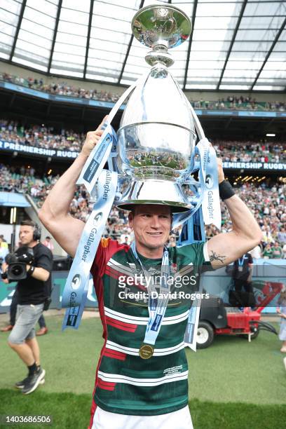 Freddie Burns of Leicester Tigers puts the Gallagher Premiership Trophy on their head as they celebrate their side's win after the final whistle of...