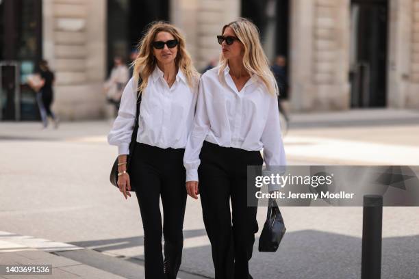 Sue Giers seen wearing a black Celine sunglasses, a white shirt blouse from SoSue, a black pants from SoSue, a golden Clash De Cartier bracelet,...