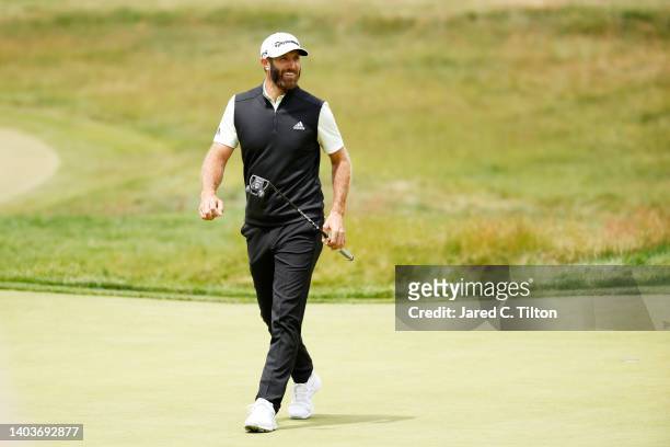 Dustin Johnson of the United States smiles after making long putt for par on on the fourth green during the third round of the 122nd U.S. Open...