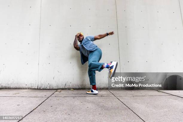 fashionable male professional dancer on urban sidewalk, full length - blue trousers stock pictures, royalty-free photos & images