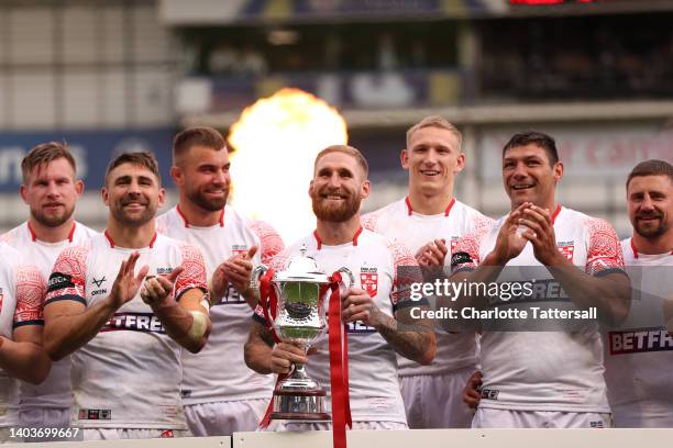 Captain Sam Tomkins of England lifts the trophy as England celebrate after victory in the Men's International Friendly match between England and...