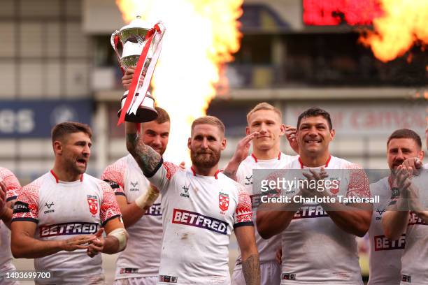 Captain Sam Tomkins of England lifts the trophy as England celebrate after victory in the Men's International Friendly match between England and...