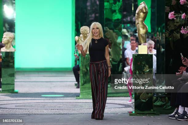 Fashion designer Donatella Versace acknowledges the applause of the audience at the Versace fashion show during the Milan Fashion Week S/S 2023 on...