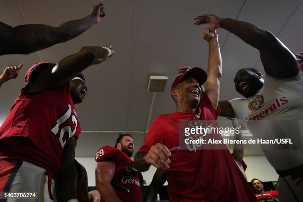 Head coach Mike Riley of the New Jersey Generals celebrates with players in the locker room after defeating the Philadelphia Stars 26-23 at Legion...