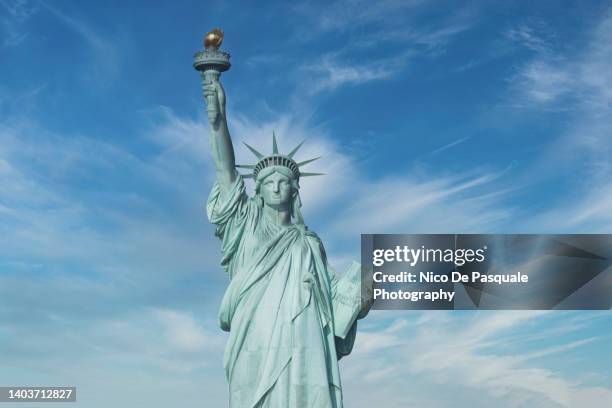 statue of liberty against blue sky - liberty island stock pictures, royalty-free photos & images