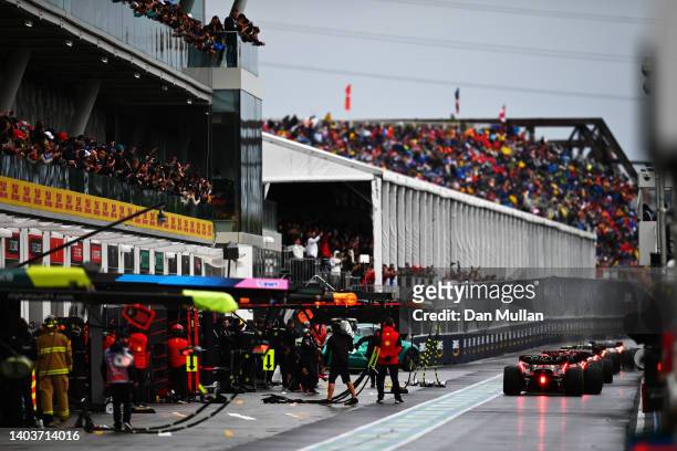 Cars line up at the end of the pitlane during qualifying ahead of the F1 Grand Prix of Canada at Circuit Gilles Villeneuve on June 18, 2022 in...