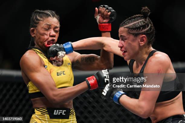 Maria Oliveira of Brazil and Gloria de Paula of Brazil exchange strikes during their women’s strawweight fight at the UFC Fight Night event at Moody...