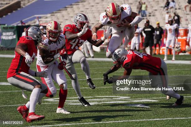 Alex McGough of the Birmingham Stallions leaps over Stephen Griffin of the Tampa Bay Bandits to score a touchdown in the second quarter of the game...