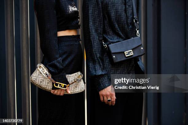 Couple Sebastien Roques & Alice Barbier wearing button shirt, black cropped top, pants, shorts, Fendi bag with logoseen outside Fendi during Milan...