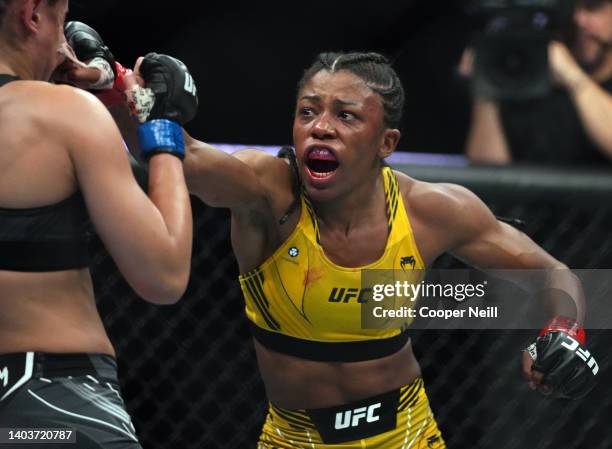 Maria Oliveira of Brazil punches Gloria de Paula of Brazil in a strawweight fight during the UFC Fight Night event at Moody Center on June 18, 2022...