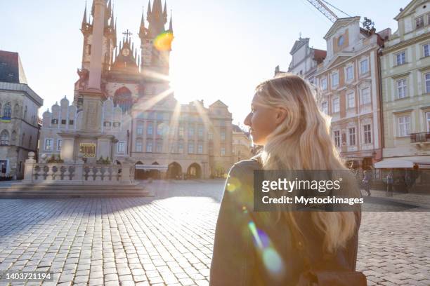 young woman wandering in the city streets of prague - prague stock pictures, royalty-free photos & images