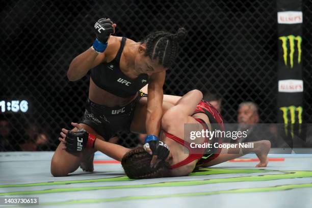 Natalia Silva of Brazil punches Jasmine Jasudavicius of Canada in a flyweight fight during the UFC Fight Night event at Moody Center on June 18, 2022...