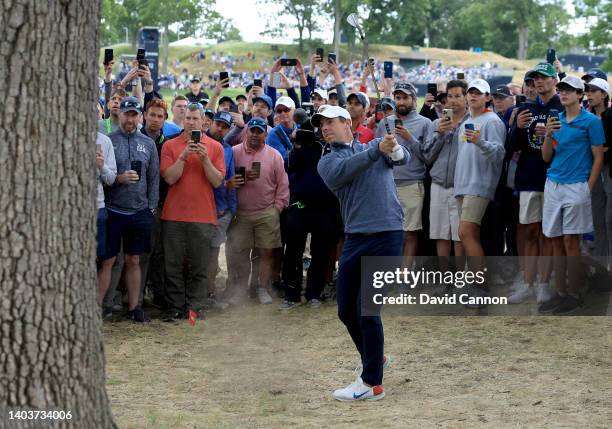 Rory McIlroy of Northern Ireland plays his second shot on the 13th hole during the third round of the 2022 U.S.Open at The Country Club on June 18,...