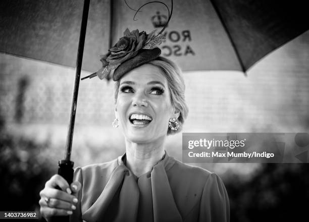 Charlotte Hawkins shelters under an umbrella as she attends day 5 of Royal Ascot at Ascot Racecourse on June 18, 2022 in Ascot, England.