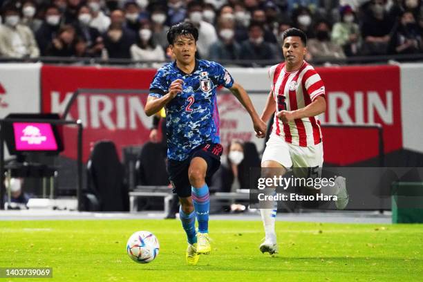 Miki Yamane of Japan in action under pressure from Blas Riveros of Paraguay during the international friendly match between Japan and Paraguay at...