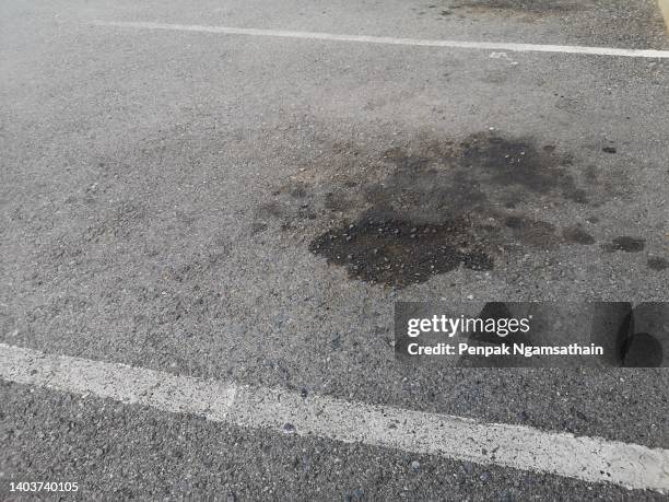 oil stains from cars on the asphalt road surface - puddle of oil stock pictures, royalty-free photos & images