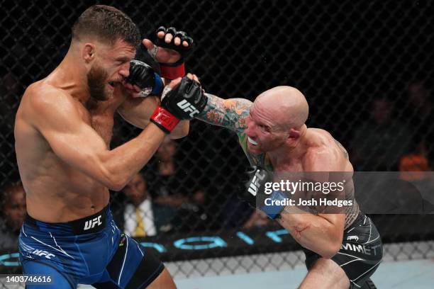 Josh Emmett punches Calvin Kattar in a featherweight fight during the UFC Fight Night event at Moody Center on June 18, 2022 in Austin, Texas.