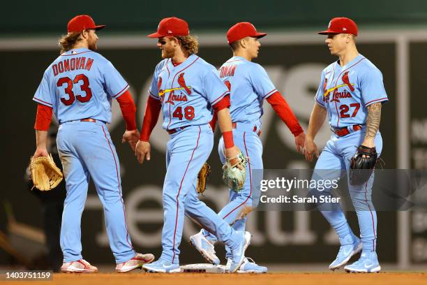 Brendan Donovan, Harrison Bader, Tommy Edman, and Tyler O'Neill of the St. Louis Cardinals high-five after the ninth inning against the Boston Red...