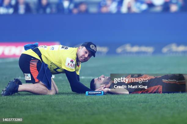 Alex Twal of the Tigers is assisted by medical staff after sustaining an injury during the round 15 NRL match between the Canterbury Bulldogs and the...