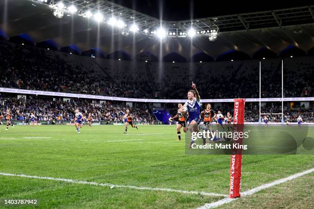 Aaron Schoupp of the Bulldogs celebrates scoring a try during the round 15 NRL match between the Canterbury Bulldogs and the Wests Tigers at CommBank...