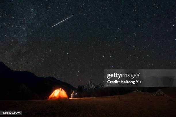 meteor strikes above camper - meteor stock pictures, royalty-free photos & images