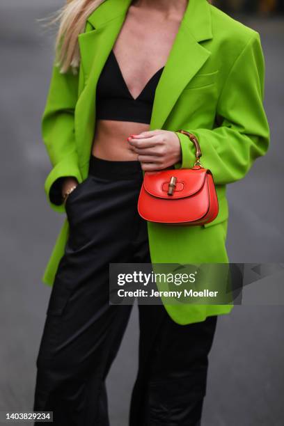 Sonia Lyson seen wearing a black bra top from Trendyol, a yellow green/acid green oversize blazer from Zara, a black satin cargo pants from Zara and...