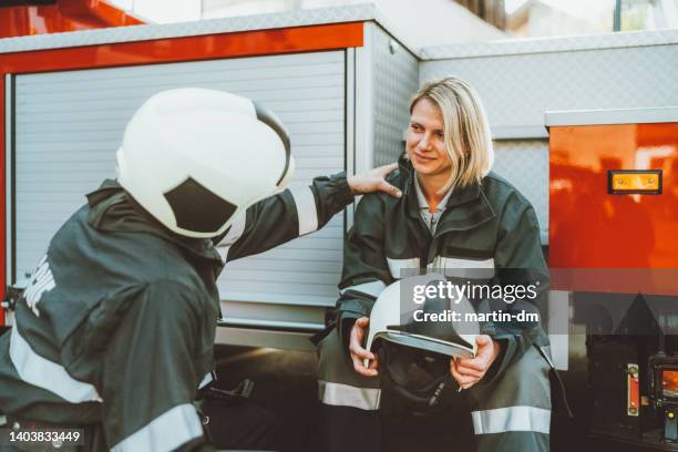 firefighter consoling colleague after a hard day - hard talk stock pictures, royalty-free photos & images