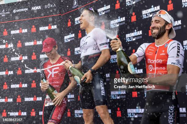 Nicolas Mann of Germany, Youri Keulen of the Netherlands and Mattia Ceccarelli of Italy pose for a picture during the flower ceremony of the IRONMAN...