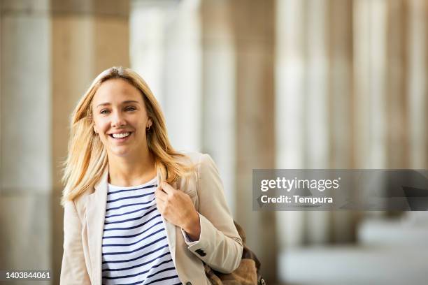 a cheerful law student is smiling at the camera. - law student stock pictures, royalty-free photos & images