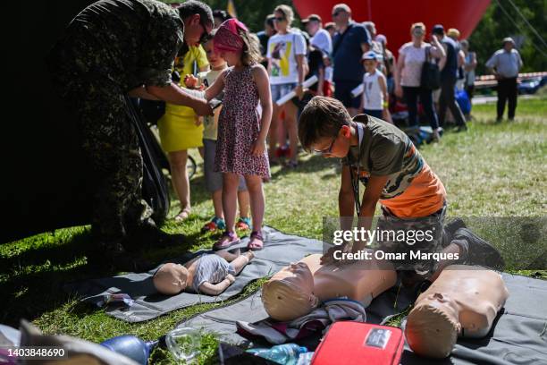 Child learns first aid during a military picnic organized by the Foundation GROT and branches of the Polish army on June 19, 2022 in Siemianowice,...